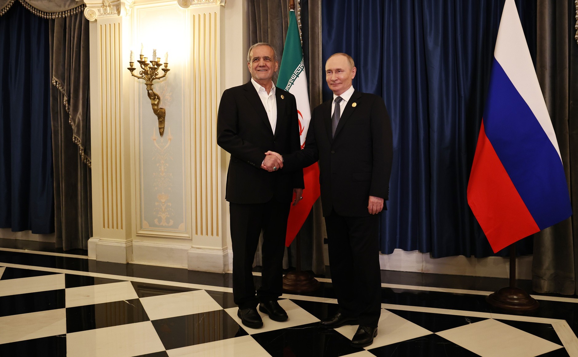 Handshake between Russian and Iranian leaders during bilateral talks on strategic cooperation